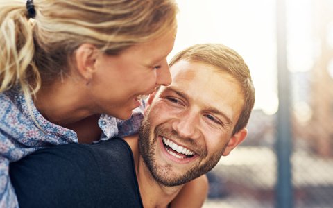 happy couple with beautiful smiles they got with dental veneers in Huntington NY