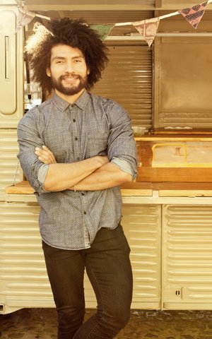 happy man standing in front of a food truck near Centerport