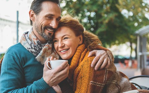 happy couple hugging who received gum disease treatment in Huntington NY