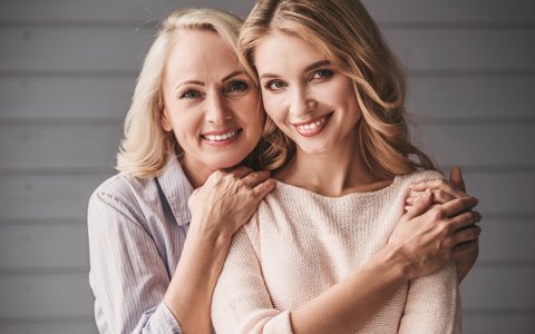 woman and her mother who has permanent dentures