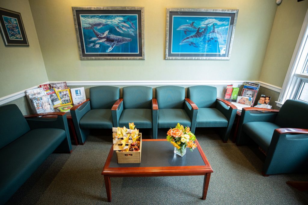 Green chairs in a dental waiting room in Huntington, NY