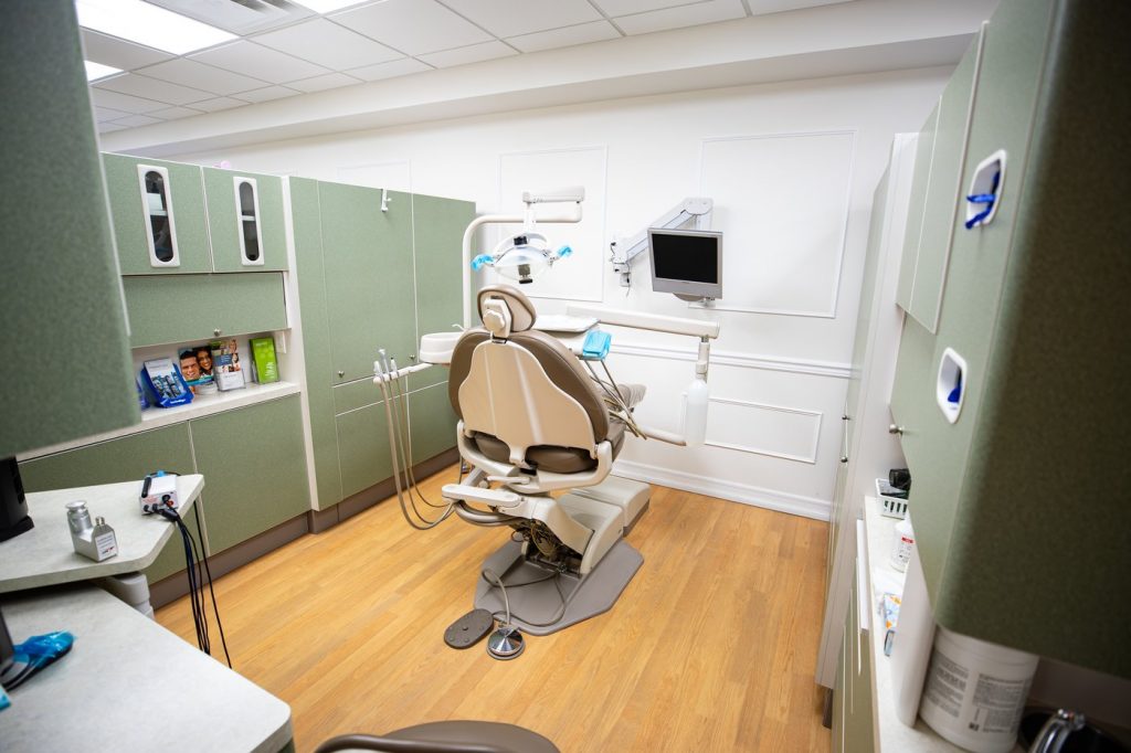 Dental exam room with dentist's chair and tv screen in Huntington, NY