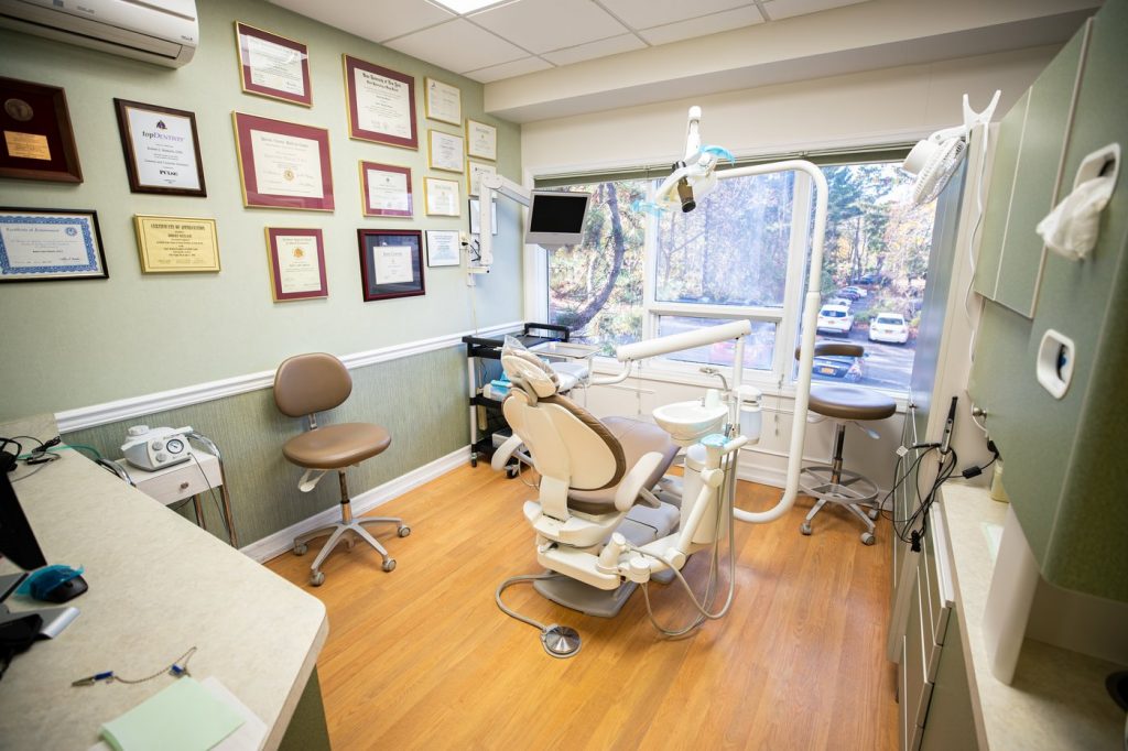 Dentist's chair at Robert Matlach Dental in Huntington New York with natural light and degrees on the wall