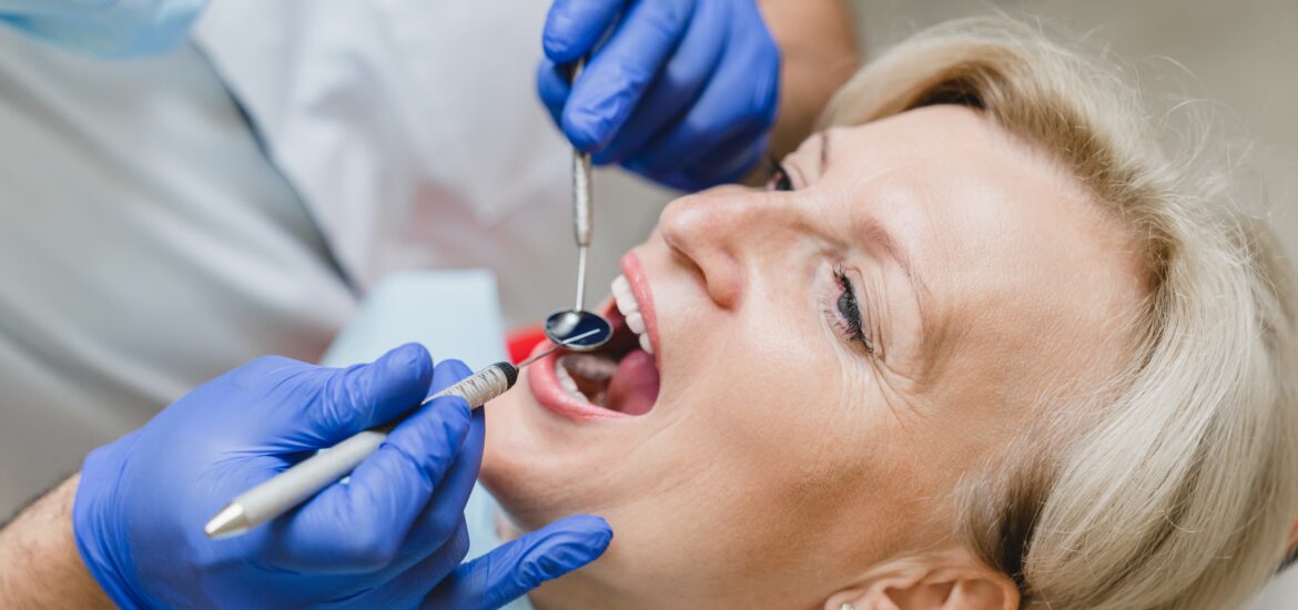 woman having her tooth infection examined, need for root canal