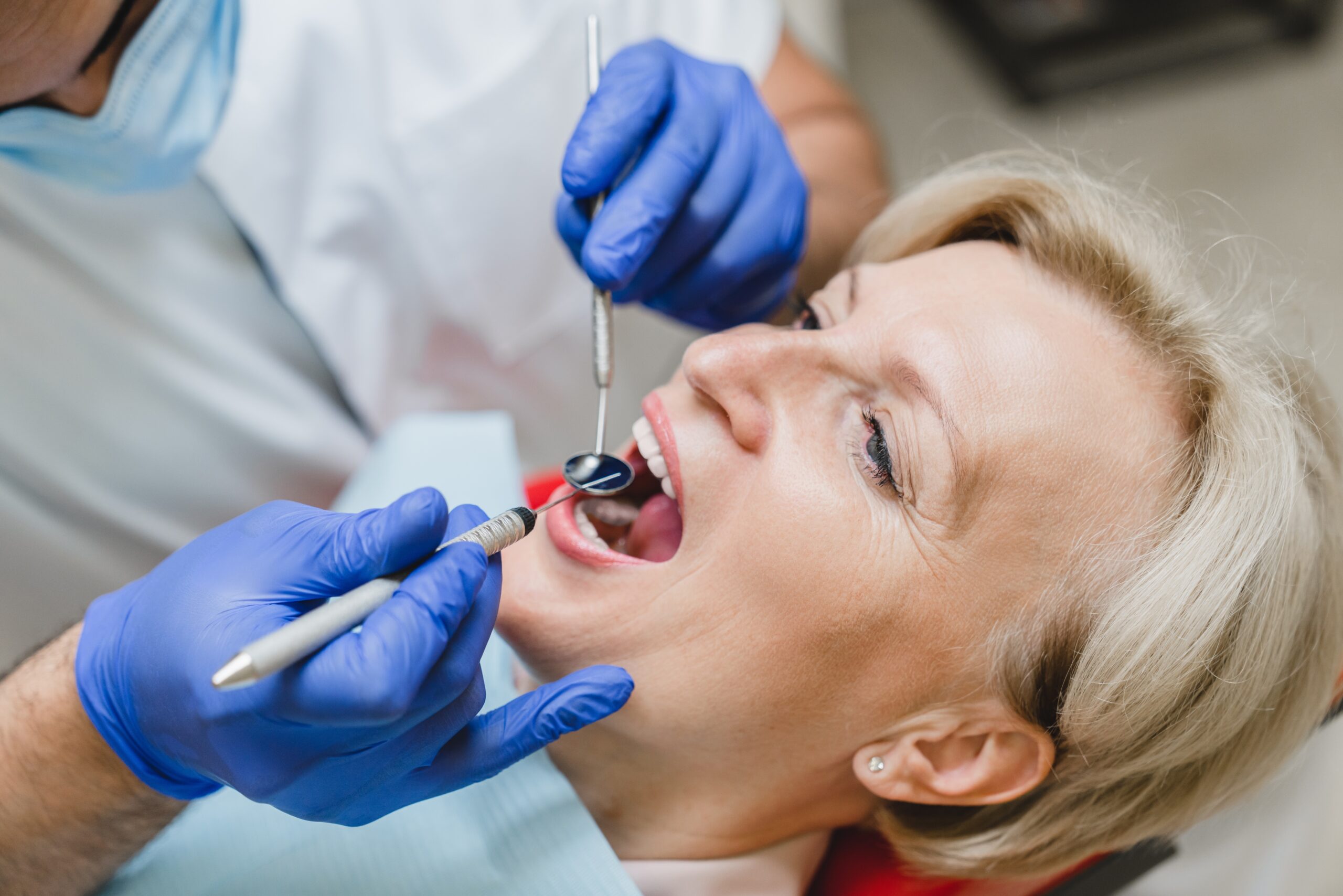 woman having her tooth infection examined, need for root canal