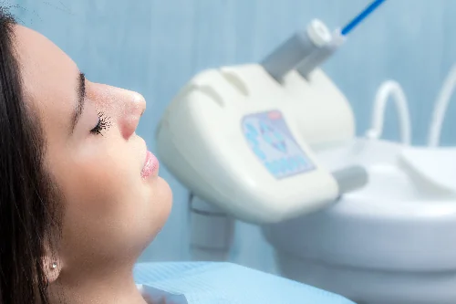 young woman relaxed in dental chair, routine checkup
