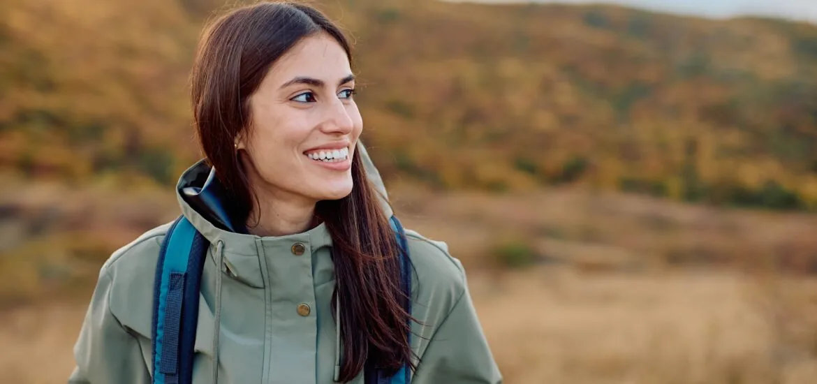 happy woman smiling outdoors, perfect white teeth