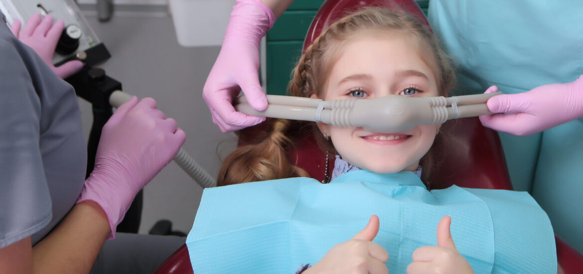 A little girl feels comfortable trying dental sedation, laughing gas